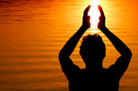 Silhouette of someone holding sun